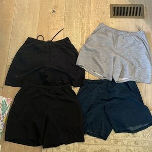 4 pairs of Large Lulu Lemon pace breaker shorts. With and without liner